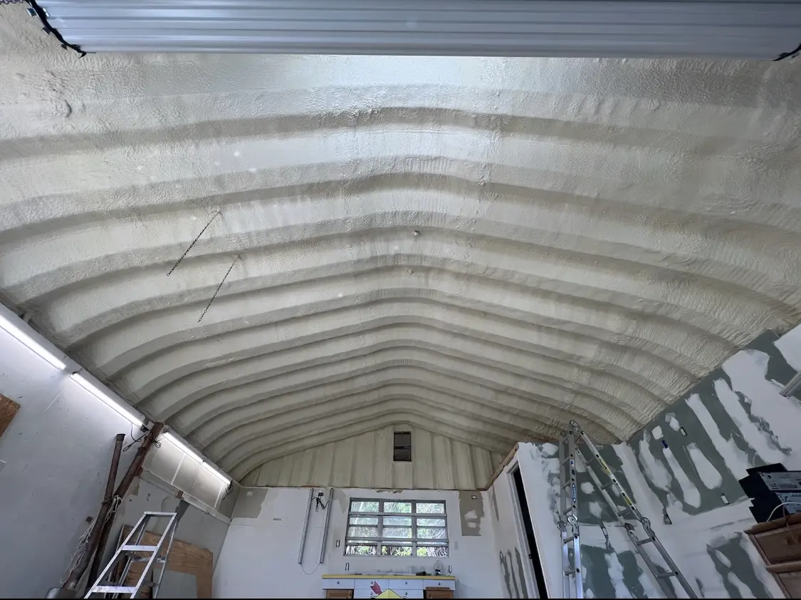 Spray polyurethane foam applied to the underside of a metal roof deck in Webster City